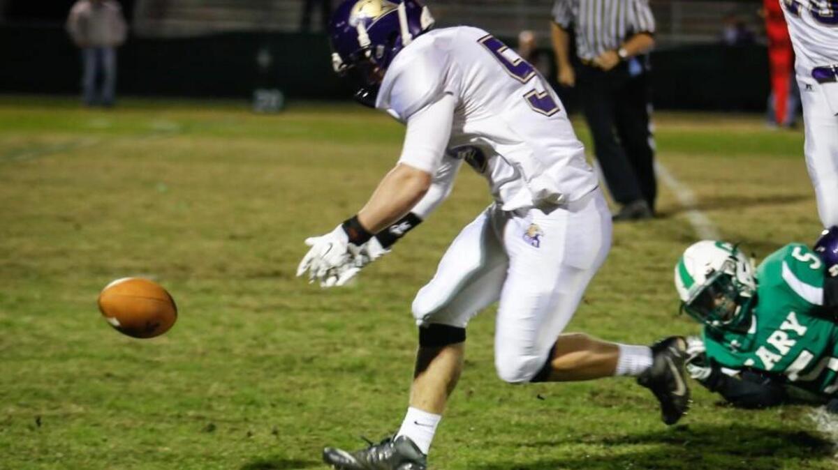 Holly Springs’ Dawson Wright (59) recovers a fumble for an early touchdown as Cary's Isaiah Gibbons (5) look on during Holly Springs' football game at Cary on Friday, October 30, 2015.
