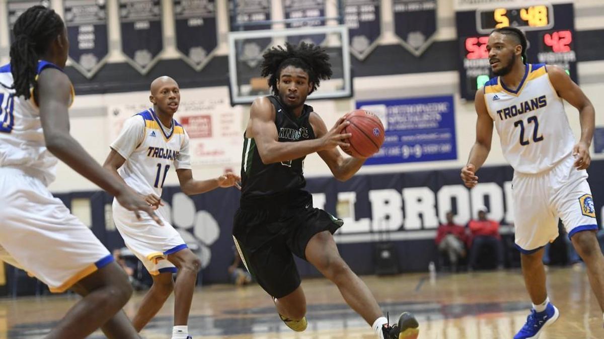 Coby White (0) of Greenfield dribbles between Sal-Bay Young, left, Marque Maultsby (10) and Kenyon Burt (22) of Garner. The Greenfield School Knights played the Garner Trojans in the Millbrook Showcase high school boys basketball event on Dec. 2, 2017.