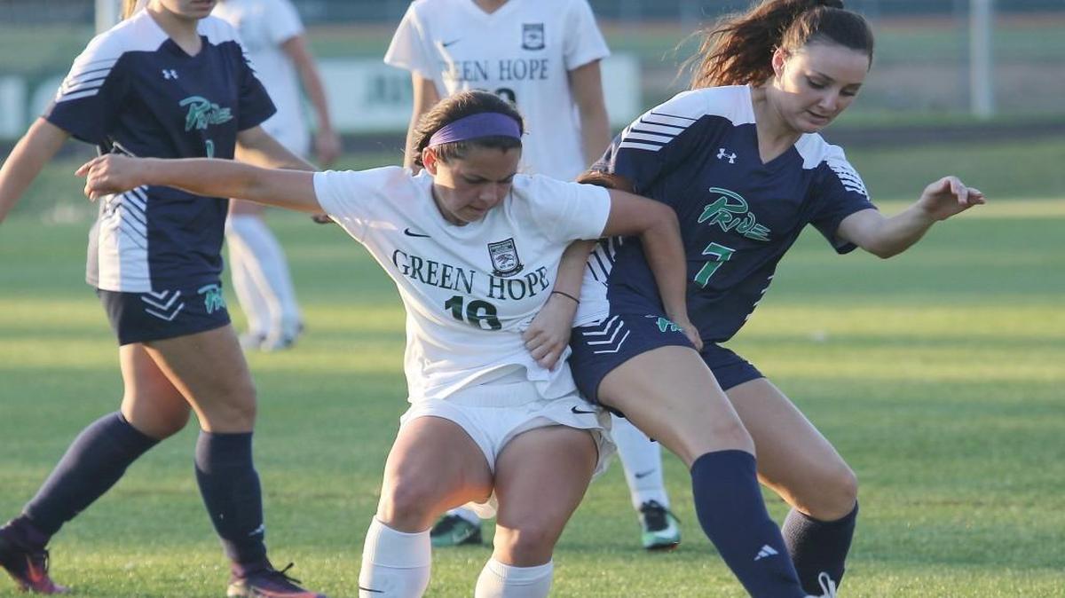 Green Hope's Taylor Cammarata (16) battles Leesville Road's Cayley Kennedy (7) for the ball during the Leesville Road high school soccer match with Green Hope high school in the third round of the state high school playoffs at Cary N.C. on May 16, 2017. Green Hope won 5-0.