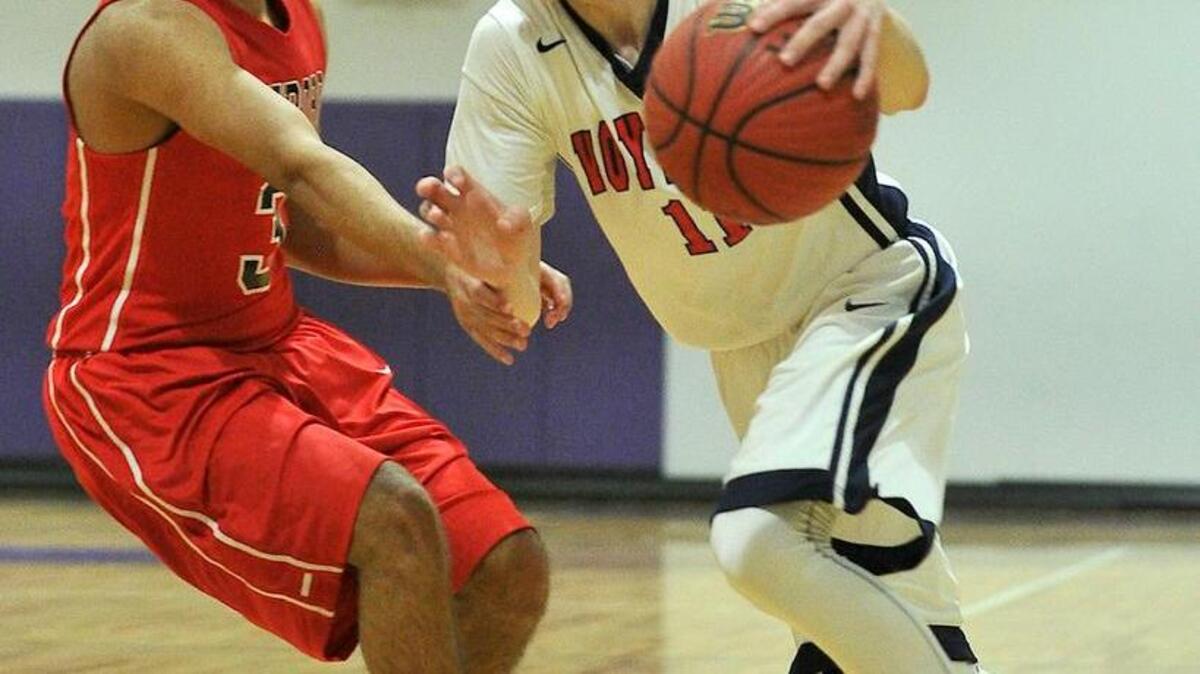 Voyager Academy's Chance Greene (11) drives towards the lane while guarded by Roxboro Community's Trey Drumwright (3) during the second half. The Voyager Academy Vikings took on the Roxboro Community School Bulldogs in the boys' final of the NCAC Conference basketball tournament at River Mill Academy in Graham, N.C. on February 19, 2016. Voyager Academy won 107-65.