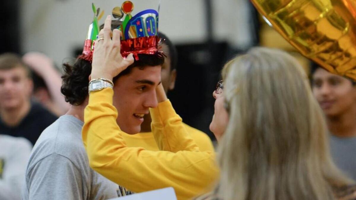 Camden Bergey, left, of Chapel Hill celebrates his 100th win at the end of the dual team match between the Chapel Hill Tigers and the J.F. Webb Warriors in Chapel Hill, N.C. on Wednesday, December 9, 2015.