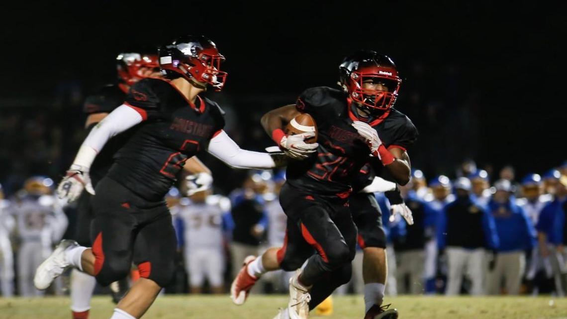 Middle Creek defender Jaden King (20) returns an interception that was later called back during Garner's third-round playoff game at Middle Creek on Friday, December 2, 2016.