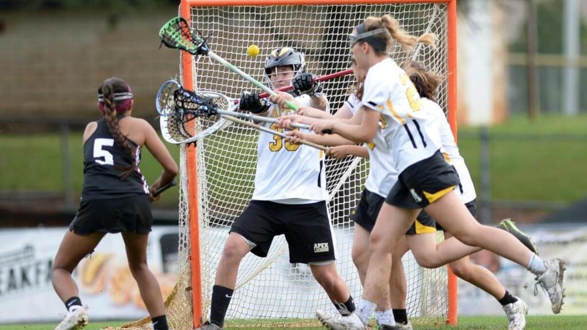 Wakefield's Andee Abrams (5), sends the ball towards the net against goalkeeper, Carrie Studdard (33). Apex Cougars played the Wakefield Wolverines in the girls lacrosse game which was played in Apex on Friday, May 7, 2016. Wakefield won 16-8.