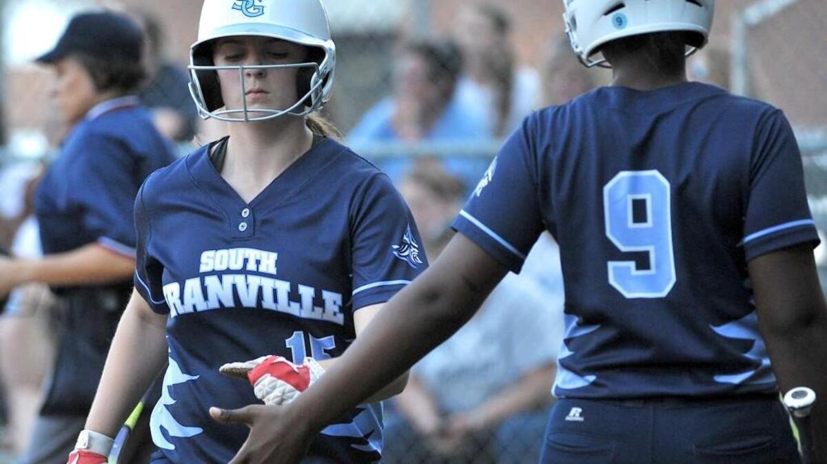 South Granville’s A'Niya JAckson (9) congratulates teammate Miranda Barker (15) after her scopred run. South Granville took on Washington in the playoff game of the NCHSAA 2A championships in Creedmoor,N.C. on May 25, 2016. South Granville won 5-4 in eleven innings