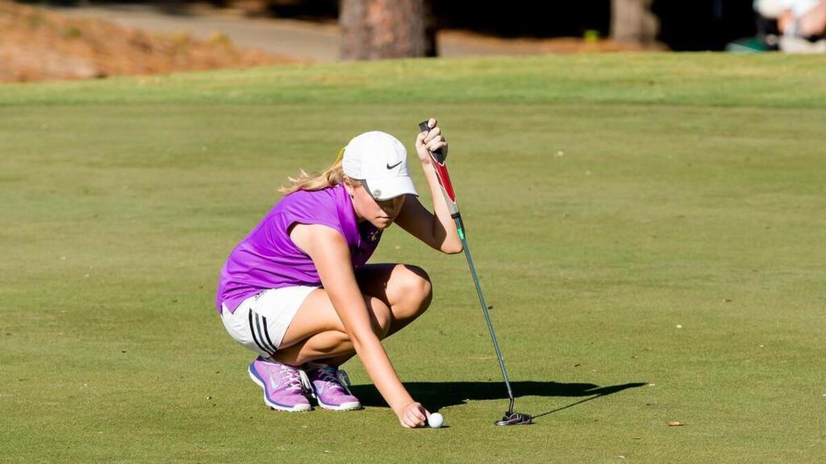 
Holly Springs' Natalie Petersen prepares to putt during the N.C. High School Athletic Association 4A girls golf state championships at Pinehurst No. 1 course. 
