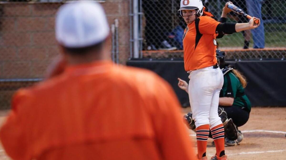 Orange's Mia Davidson (33) looks to her head coach Eddie Davidson during her at-bat during Northwood's softball game at Orange on Friday, April 15, 2016. Orange won the game 5-4 in 9 innings.