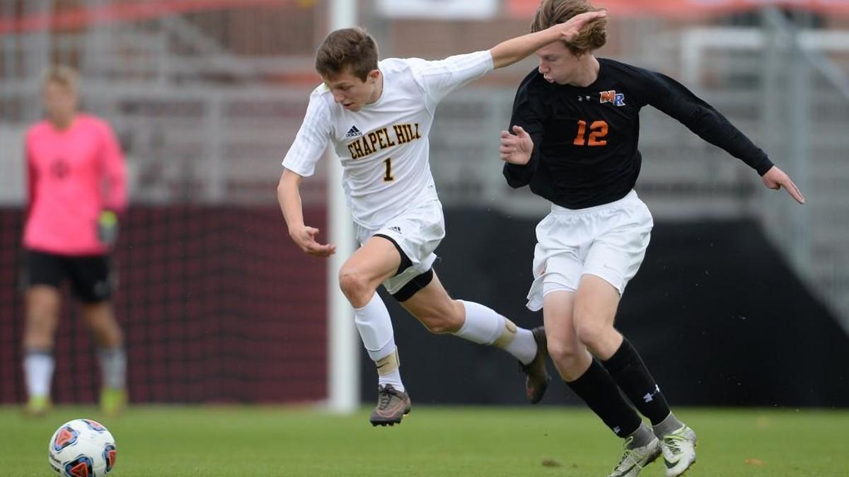 Sam Linker (1) of Chapel Hill wins the ball against Ryan Welsh (12) of Marvin Ridge. The Chapel Hill Tigers played the Marvin Ridge Mavericks in a men soccer game that counted for the NCHSAA 3A State Championship and took place at the N.C. State University Dail Stadium in Raleigh, N.C. on Saturday, November 19, 2016. Marvin Ridge won 1-0.