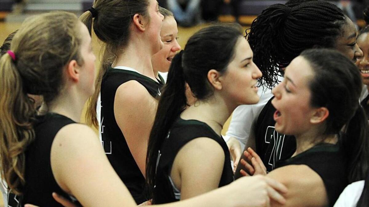 Green Hope celebrates a 54-51 win over Holly Springs on Friday in Holly Springs.