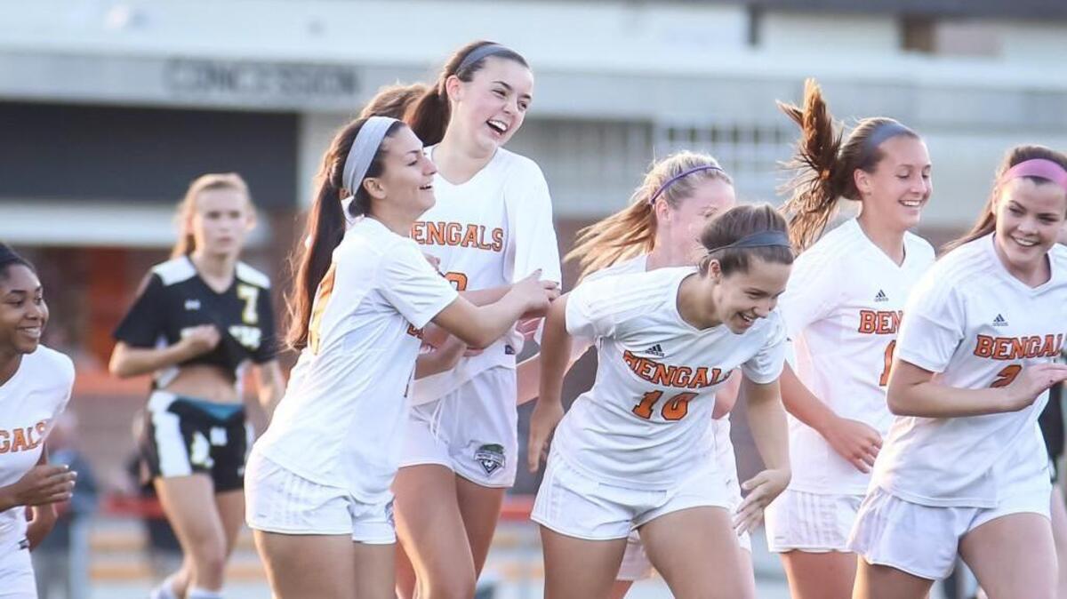 Fuquay forward Josey Wilson, center, celebrates her second-half goal to give their team the lead.The Apex Cougars played a girls soccer game against the Fuquay-Varina Tigers on Wednesday, April 11, 2018. Fuquay-Varina won the game 3-1.