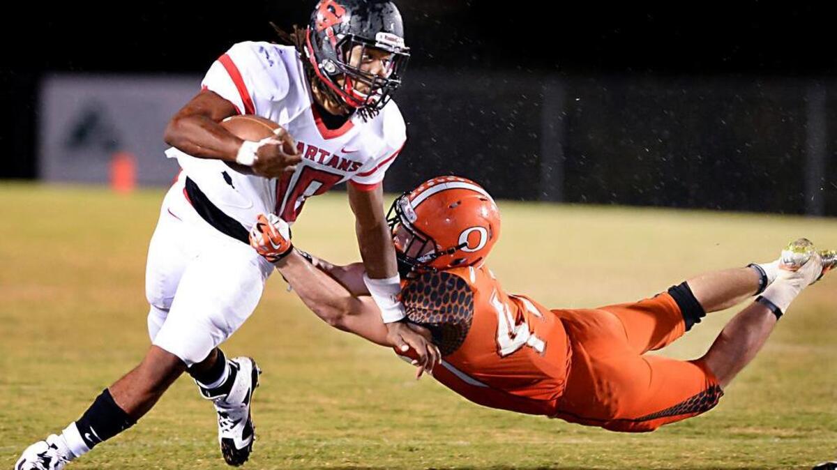 
Jordon Brown, left, of Southern Durham gains yards against a tackle from Drew Lemaster, right, of Orange. The Orange Panthers played the Southern Spartans in Hillsborough on Thursday, September 24, 2015.
