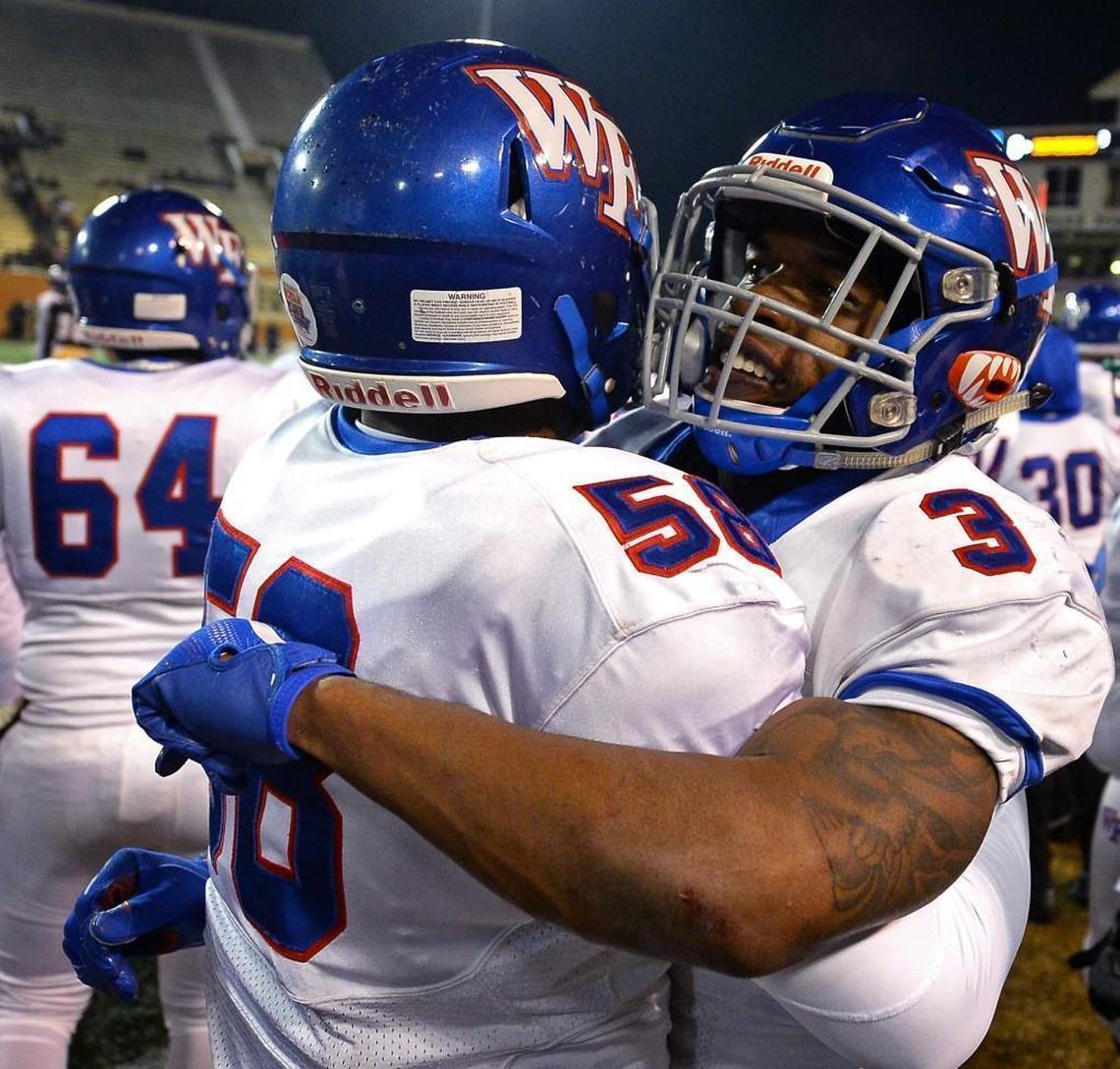 Wake Forest Cougars running back Devon Lawrence, right, embraces defensive end/linebacker Nicholas Major, left, along the team's sideline in the final moments of action against the Mallard Creek Mavericks in the 4AA Football State Championship game at BB&T Field on the campus of Wake Forest University in Winston-Salem, NC on Saturday, December 9, 2017. Wake Forest defeated Mallard Creek 21-0.