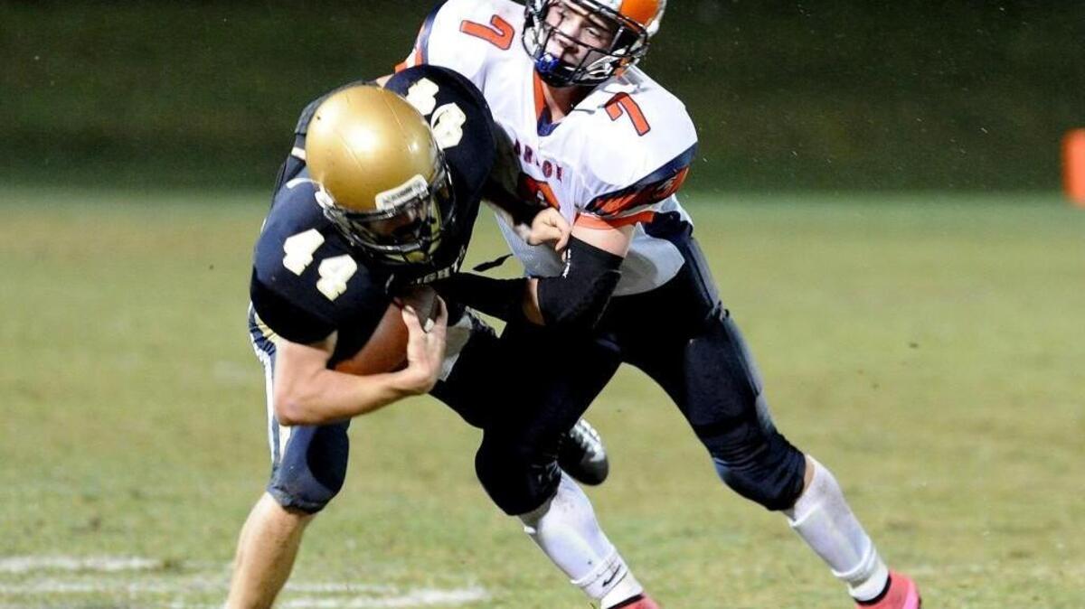 
Cary Christian’s Christian Jacobsen (44) is tackled by Grace Christian's Blake Ballance (7) during the football game on Friday, September 25, 2015 in Cary.
