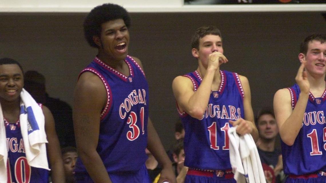 Wake Forest-Rolesville Cougars Rashad Lucas (10), Eric Williams (31), Bryan Nieman (11) and Nathan Davis (15) cheer their team mates with a few seconds left to the end of their victory against Duluth East Greyhounds on Dec. 28, 2000.