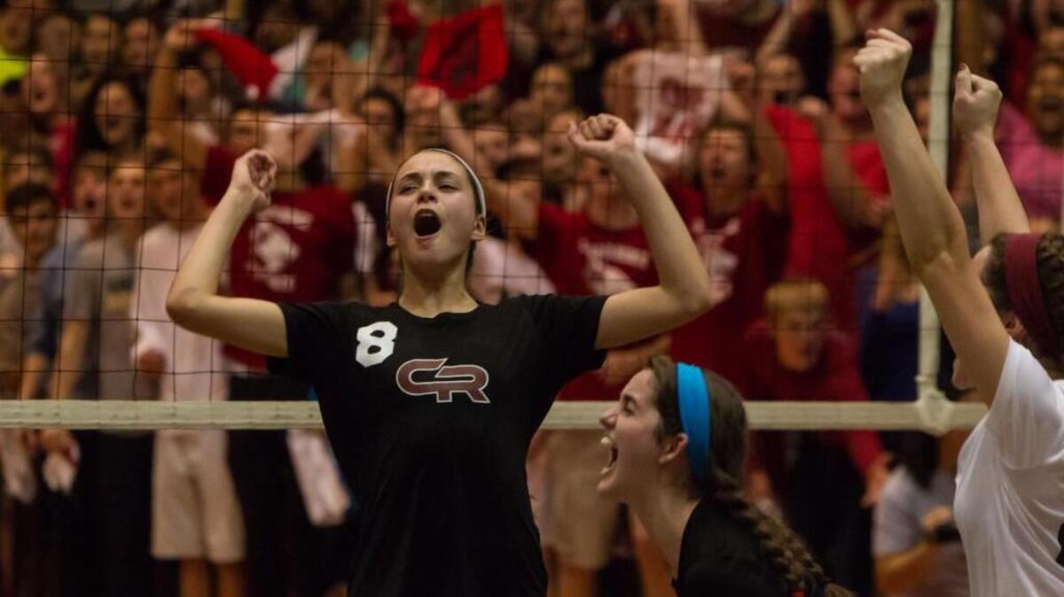 The Red Wolves celebrate a point in front of a packed crowd. The Asheboro Blue Comets and Cedar Ridge Red Wolves played their volleyball game in Hillsborough, N.C. on Tuesday, November 3, 2015. Asheboro won the regional championship 3-1.