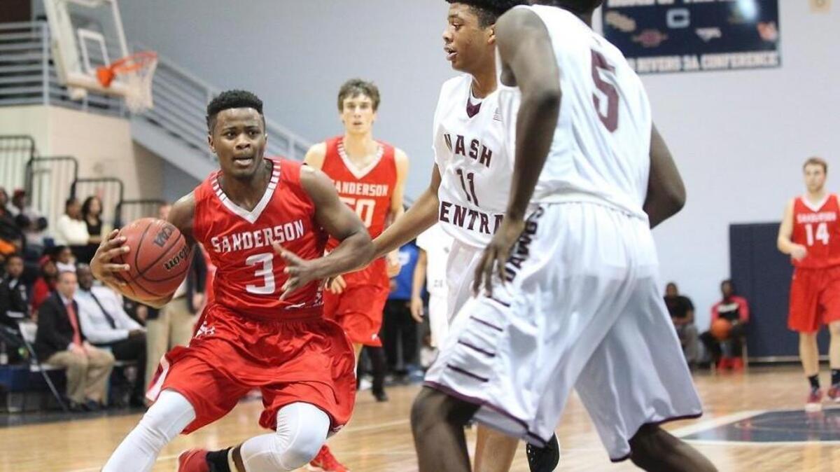 Sanderson’s Taj Thompson (3) drives the lane as Nash Central’s Elijah Cole (5) guards the lane.