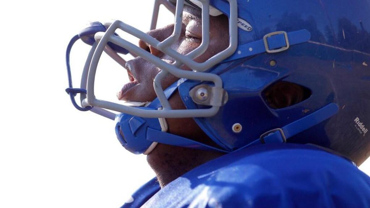 Dexter Lawrence catches his breath at the end of a running drill during a Wake Forest High School football practice on Aug. 13. Lawrence is the No. 2-ranked player in the nation, according to Rivals.com.
