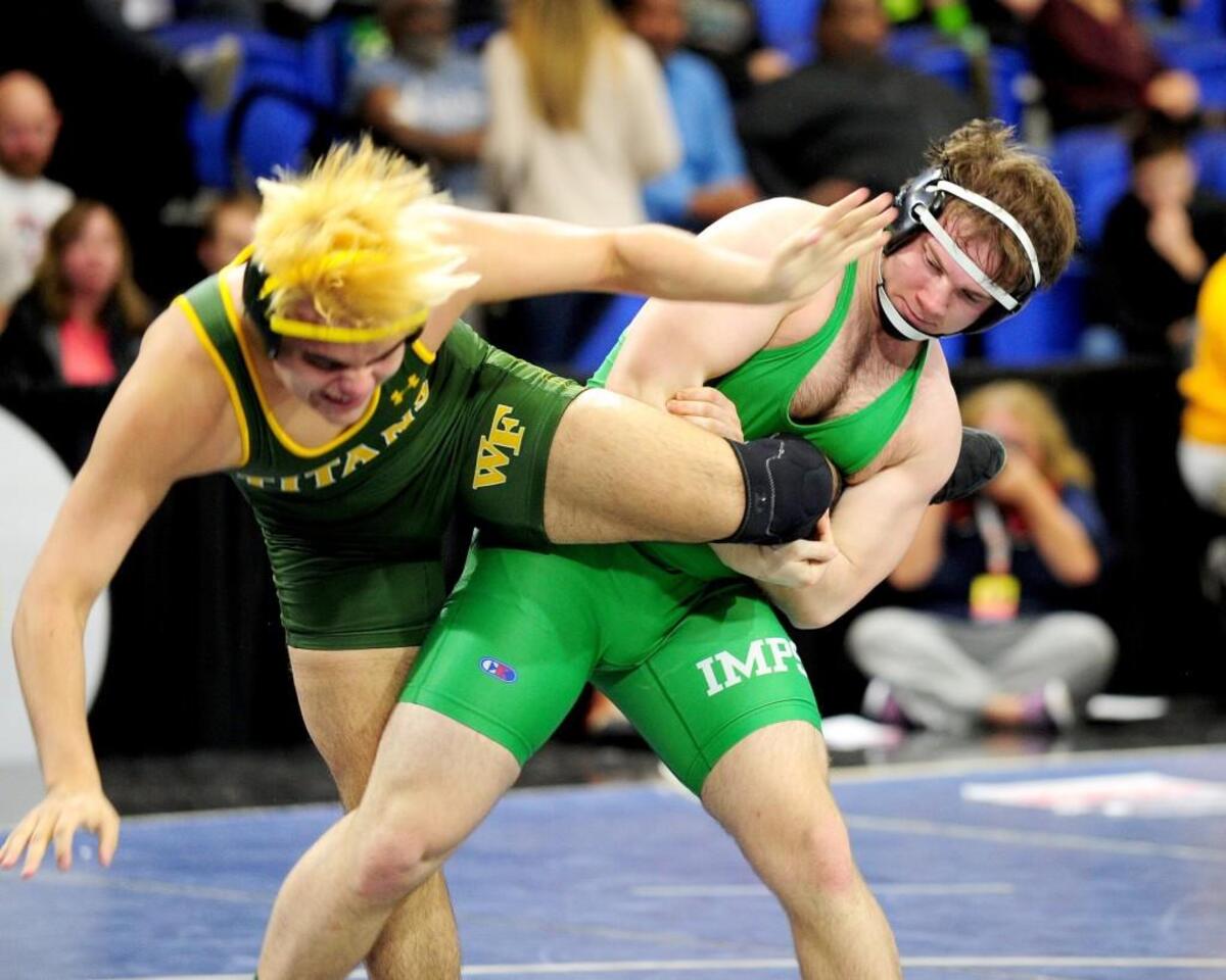Cary's Nicholas Straight (left) and West Forsyth's Gus Smith wrestle in the 182-pound class. The NCHSAA State Championship wrestling matches took place in Greensboro on Saturday, February 3, 2018.