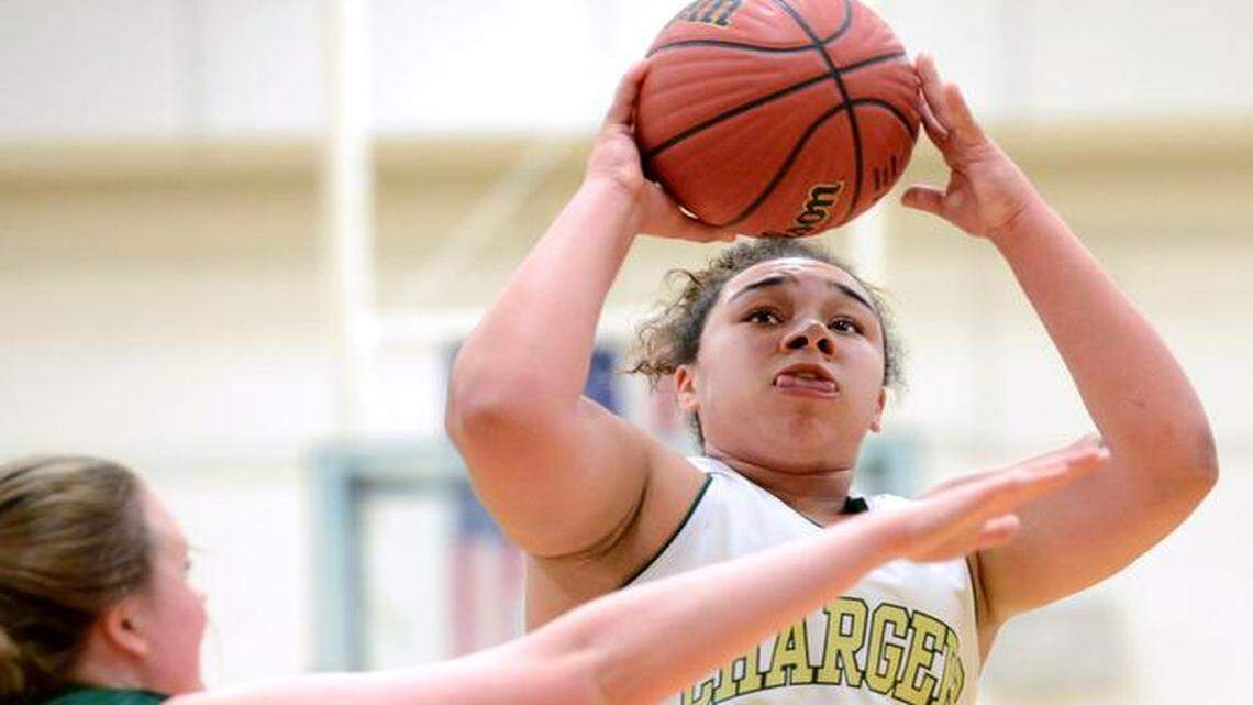 
Shontai Totten (24) of Northwood shoots for the basket against Madison Bonello (32) of Cardinal Gibbons. The Northwood Chargers played the Cardinal Gibbons Crusaders in Pittsboro, N.C. on Friday, December 19, 2014. Northwood won 65-54.
