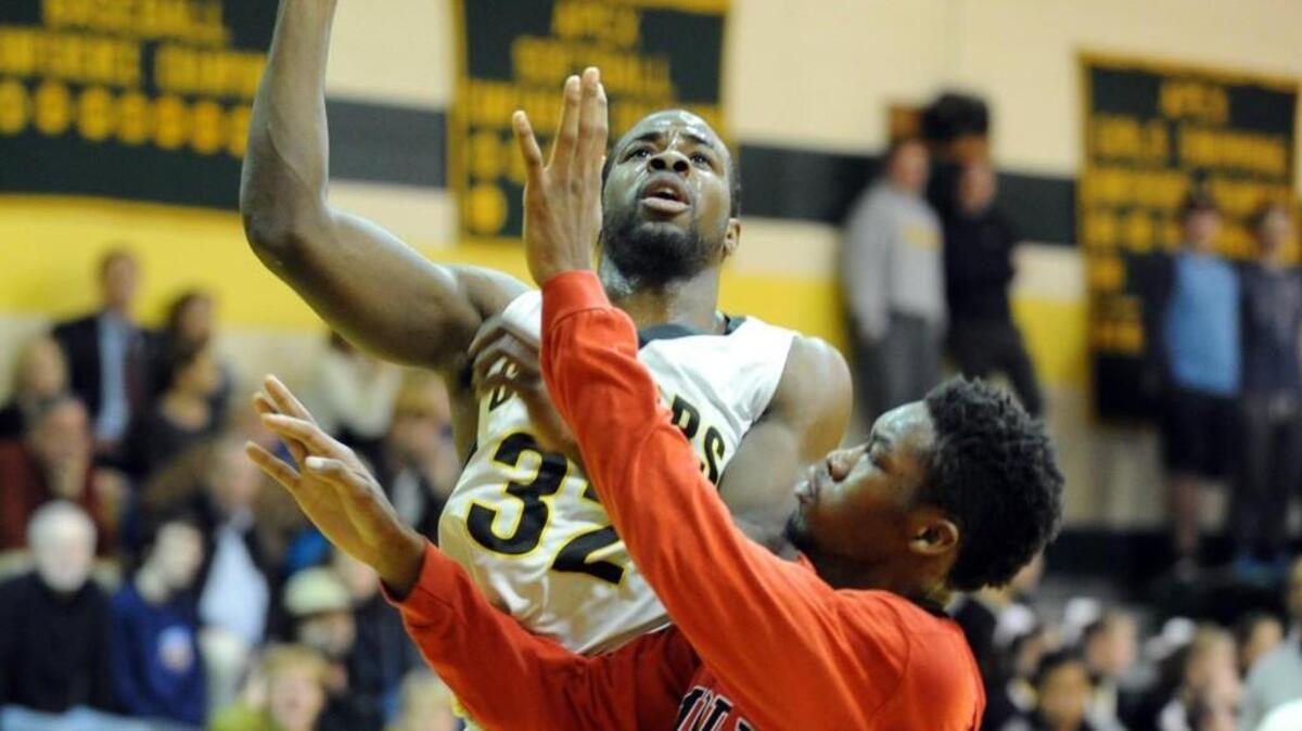 Apex's Ian Boyd (32) shoots over Middle Creek's Demetrius Bastian during the boys basketball game, which was played in Apex on February 11, 2016. Apex won 76-48.