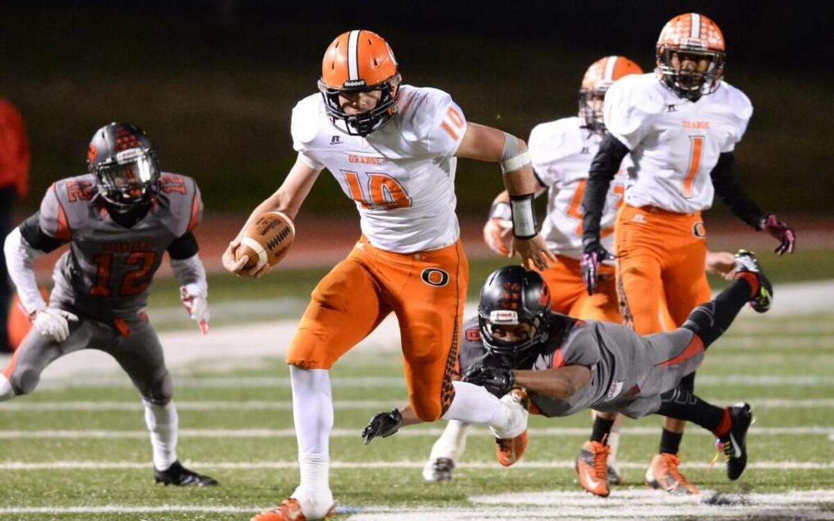 Bryse Wilson (10) of Orange carries the ball against a tackle from Jaekwon Amey (8) of Southern. The Southern Spartans played the Orange Panthers at the Durham County Memorial Stadium in Durham, N.C. on Friday, November 20, 2015.