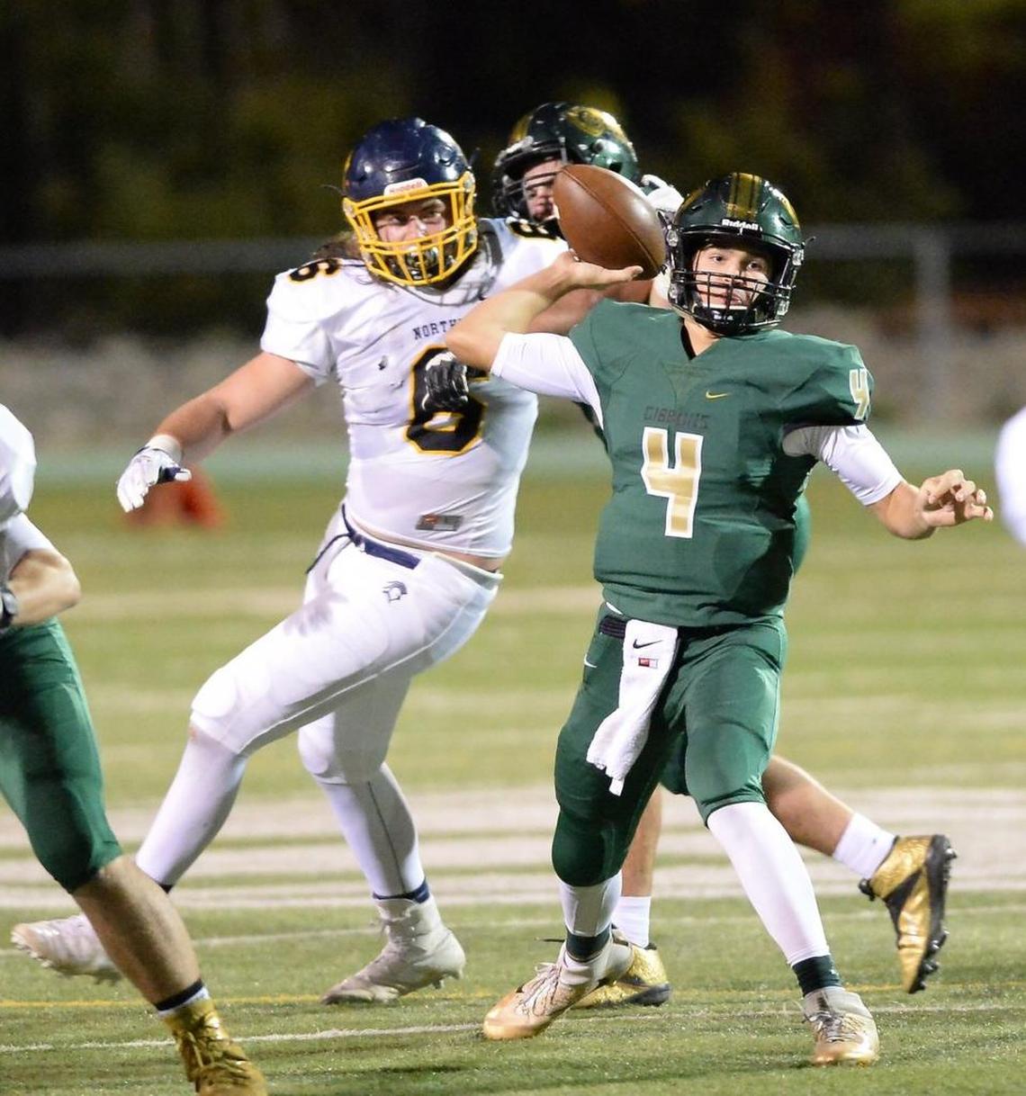 Anton Stoneking (4) of Cardinal Gibbons throws a pass under pressure from Carl Fowler (6) of Northern. The Cardinal Gibbons Crusaders played the Northern Knights in a football game that took place in Raleigh, N.C. on Friday, November 4, 2016. Cardinal Gibbons won 25-7.