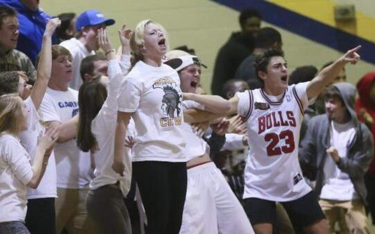 
The Trojan fans react after an acrobatic Julius Barnes layup. The Trojans of Garner High School defeated the Knights of Northern Durham High 73-61 on Tuesday in Garner.
