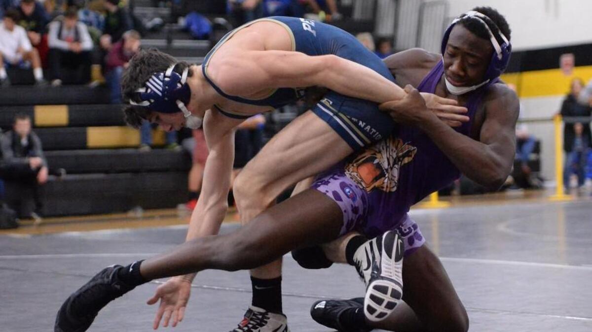 Sammy Peticos, left, of Chase wrestles Quincy Monday, right, of Carrboro during the 132 lbs final. The Tiger Holiday Classic Wrestling Tournament was hosted by Chapel Hill High School in Chapel Hill, N.C. on Friday, December 23, 2016.
