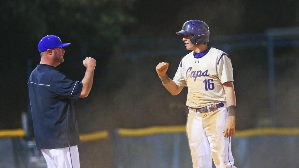 Broughton head coach Jere Morton congratulates Joe Barrow (16) after his extra bases hit in the 4th inning. Broughton defeated Cornith Holders 12-2 to win the championship.
