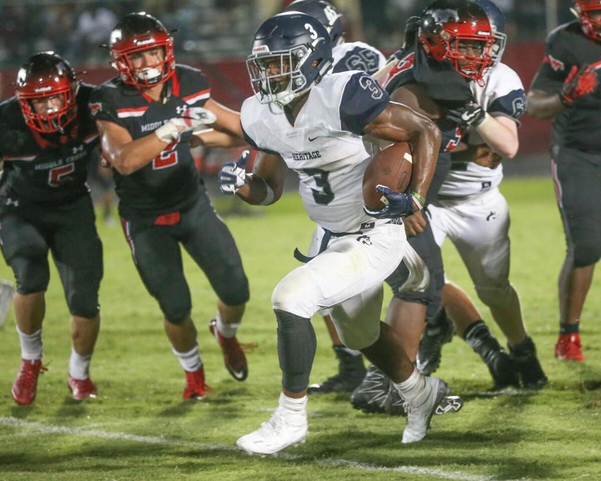 Heritage's Ricky Person (3) breaks loose for a 63 yard touchdown run with 3:35 left in the game to the Huskies up 40-27. Coverage from Heritage Huskies and the Middle Creek Mustangs played in Apex, N.C. on Friday, August 25, 2017. Heritage defeated Middle Creek 47-27.