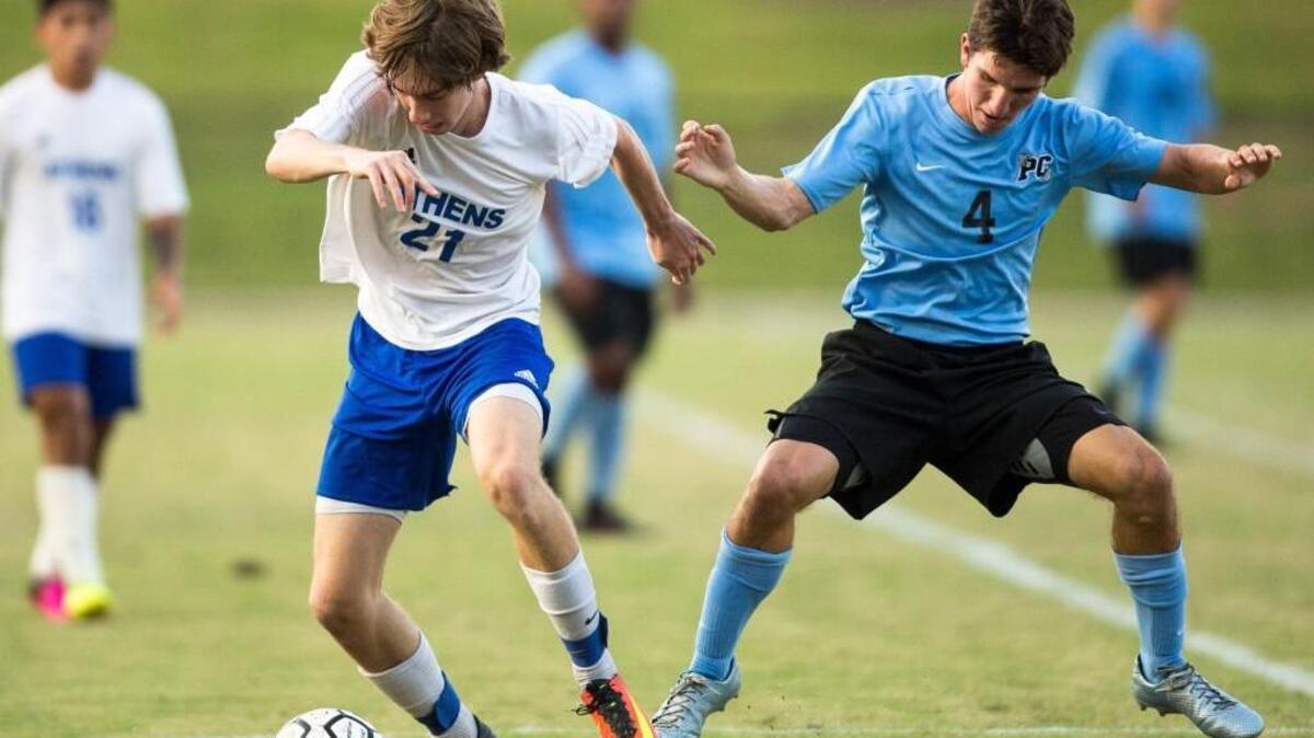 Athens Drive’s Michael O’Leary (21) and Panther Creek’s Cameron Schler (4) battle for the ball during a high school soccer game in Raleigh, N.C. on Wednesday, Sept. 7, 2016.
