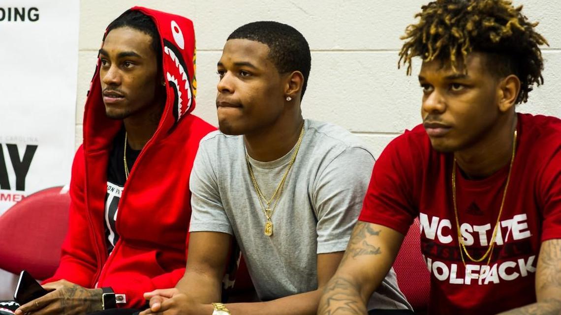 Trinity Chrisitian’s Dennis Smith (middle) Cat Barber (N.C. State, left) and Shaun Kirk (NC State, right) watch the games at the HighSchoolOT.com Holiday basketball tournament at Broughton High School in Raleigh on Monday, December 28, 2015.