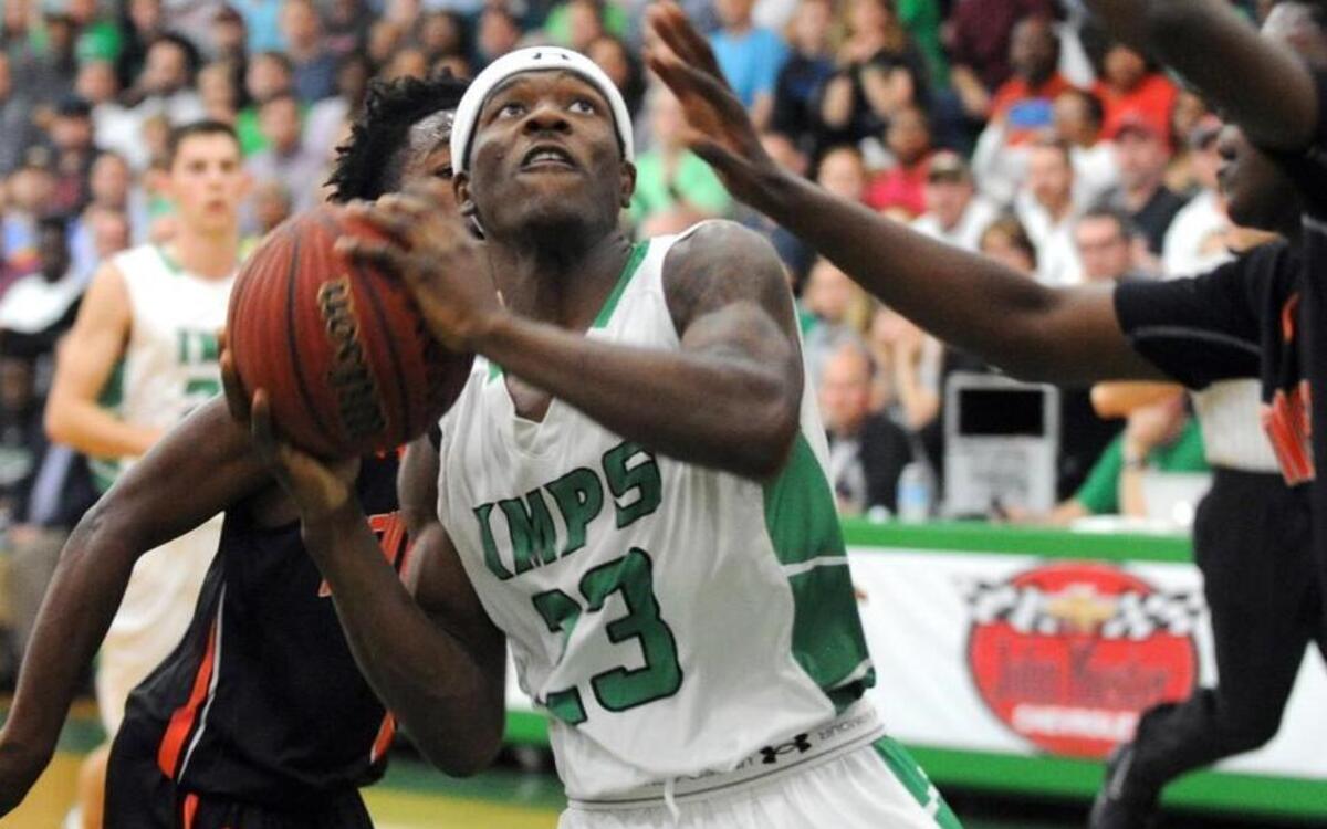 Cary's Donte Tatum (23) shoots against New Hanover during the fourth round of the NCHSAA 4A boys basketball playoffs, which was played in Cary on Tuesday, March 1, 2016. Cary won 58-49 in overtime.