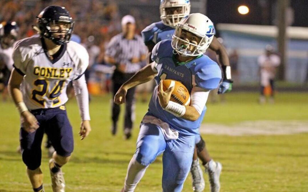 JH Rose quarterback Ryan Goodwin (11) keeps the ball for a touchdown during the first half of DH Conley High School football game against JH Rose High School in Greenville, N.C. on Friday, September 23, 2016.