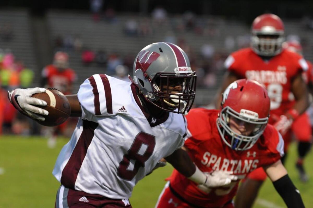 Wakefield's Chad Norfleet (8) straight-arms Sanderson's Jack Ellis (15) during the football game, which was played in Raleigh on Friday, September 23, 2016.