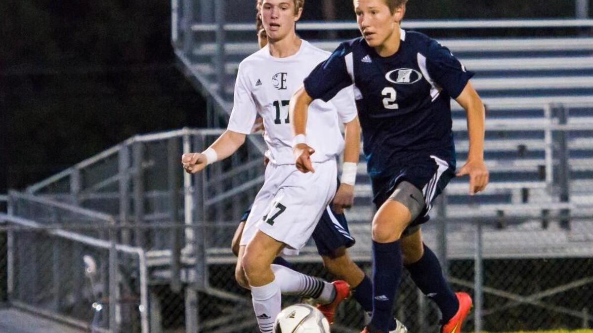 
Heritage’s Trevor Berk (2) keeps the ball in front of Enloe's Luke Buxton (17) during a soccer game on Wednesday, October 14, 2015 in Raleigh, N.C. Heritage and Enloe tied 5-5.
