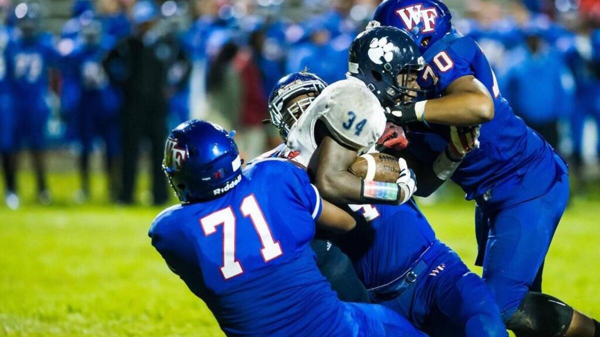 
Millbrook's Larry Rountree III (34) is tackled by a host of Wake Forest defense during a football game on Monday, October 5, 2015 in Wake Forest, N.C. Wake Forest Cougars won 28-7.
