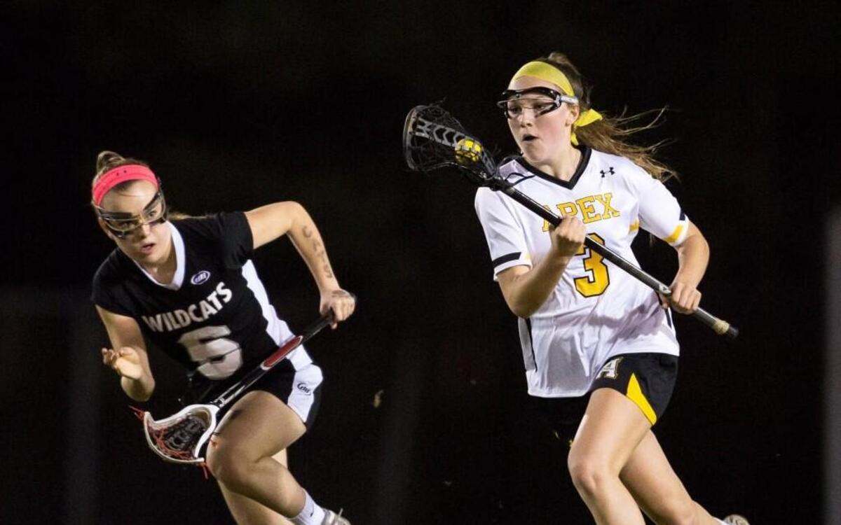 Apex's Tess Meurling (3) runs with the ball while East Chapel Hill's Sasha Bull (6) defends during a high school lacrosse game in Apex, N.C. on Monday, March 7, 2016.