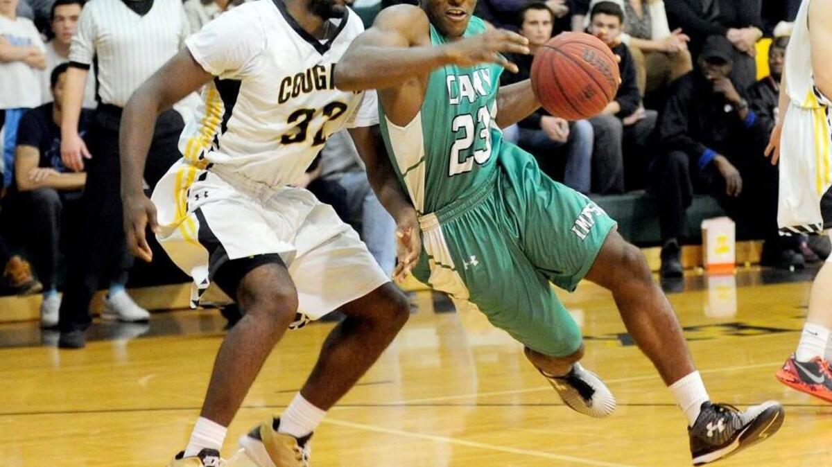 Cary’s Donte Tatum (23) pushes past Apex's Ian Boyd (32) during the boys basketball game, which was played on Friday, December 4, 2015 in Apex. Cary won 63-51.