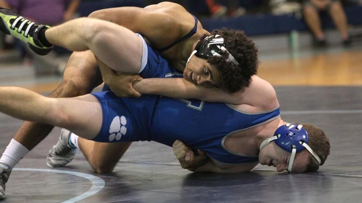 Cleveland’s Quinton Ross drives Neuse Charter’s William Christian into the mat during Wednesday’s match.