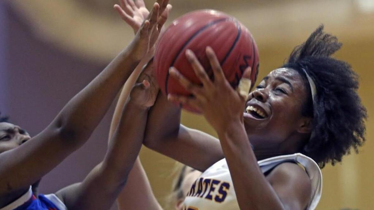 Faith Weidner (12) of Corinth Holders is fouled as she drives into the lane for a layup.