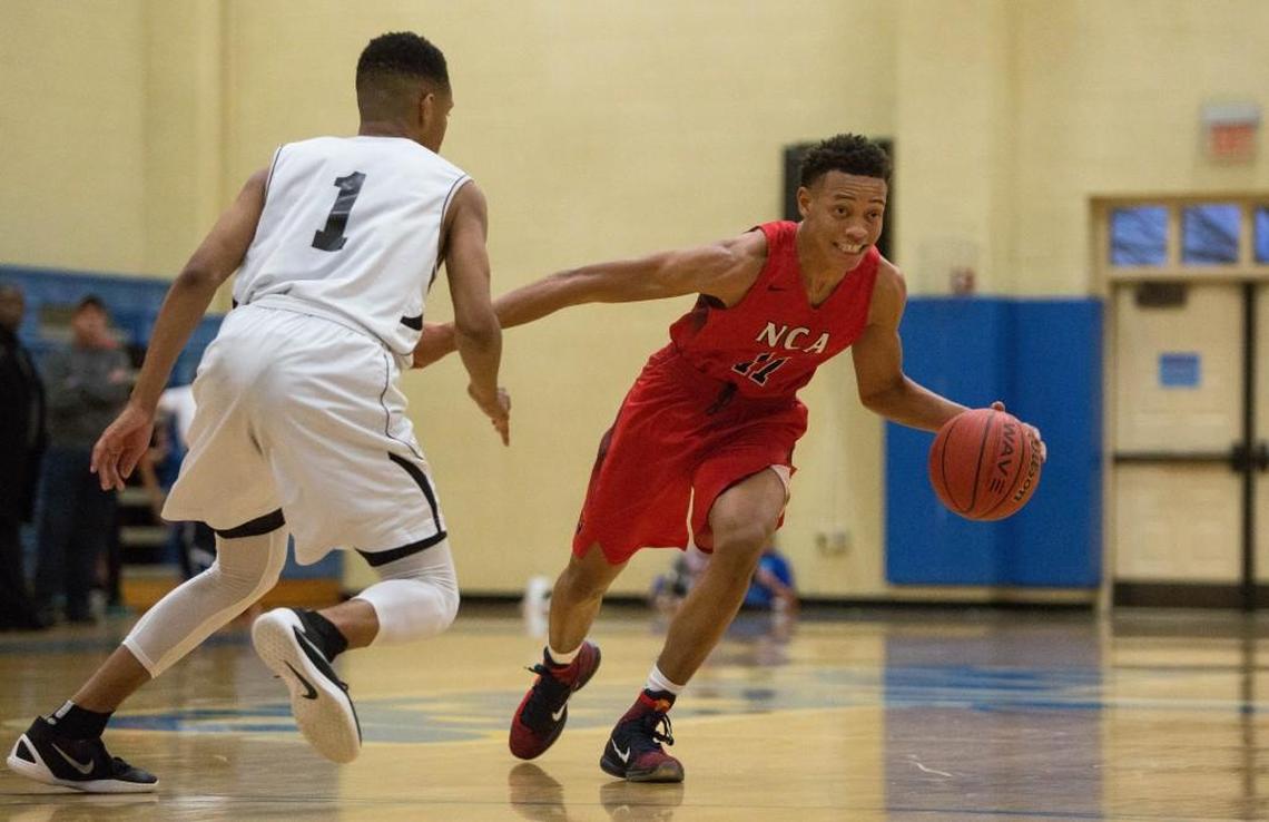 Neuse Christian Academy's Kaleb Hunter (11) dribbles the ball as Cape Fear Christian Academy's Quentin Jackson Jr. (1) defends during a high school basketball game in Cary, N.C. on Thursday, Feb. 18, 2016.