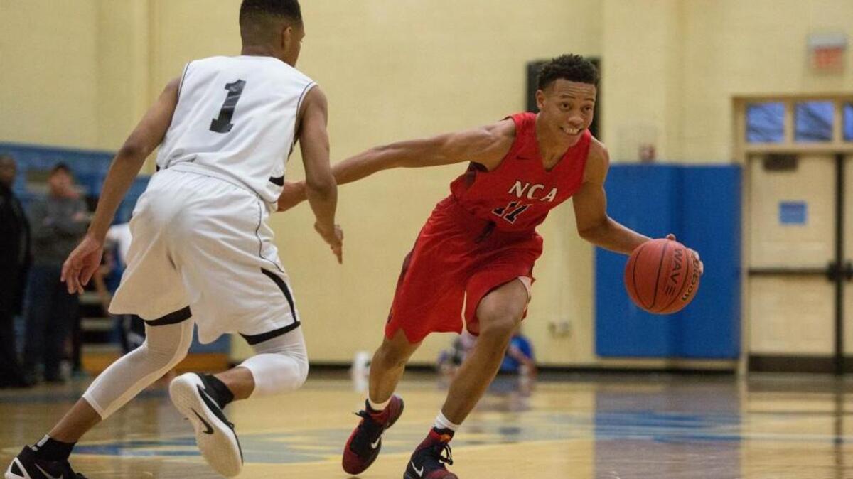 Neuse Christian Academy's Kaleb Hunter (11) dribbles the ball as Cape Fear Christian Academy's Quentin Jackson Jr. (1) defends during a high school basketball game in Cary, N.C. on Thursday, Feb. 18, 2016.