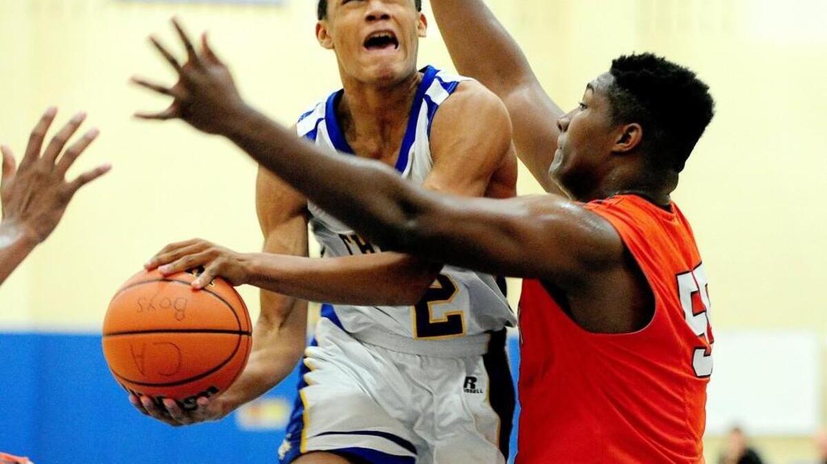 Cary Academy’s Tylor Moore (2) shoots against Norfolk Academy's David McCormack (right) during the boys basketball game, which was played in Cary on Tuesday, December 29, 2015. Cary Academy won 49-46.