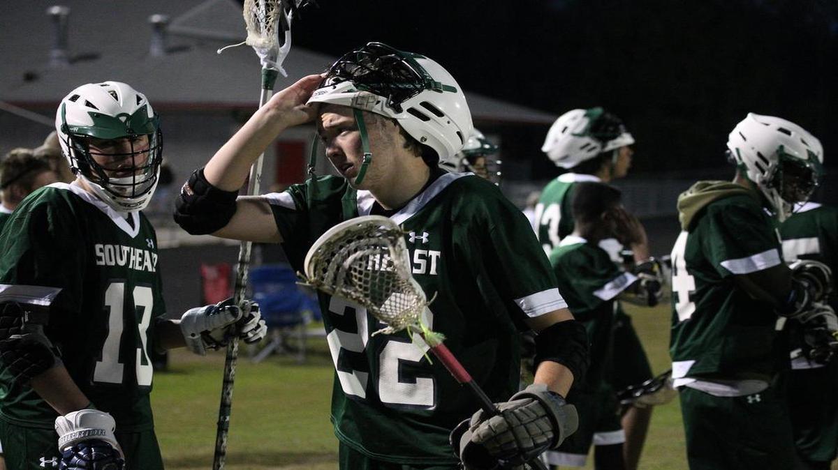 Southeast Raleigh's Kyle Muhs (22) comes to the sidelines for a breather during the Southeast Raleigh Bulldogs high school lacrosse game with the Southern Durham high school on April 5, 2017. Southeast Raleigh won the game 5-4.
