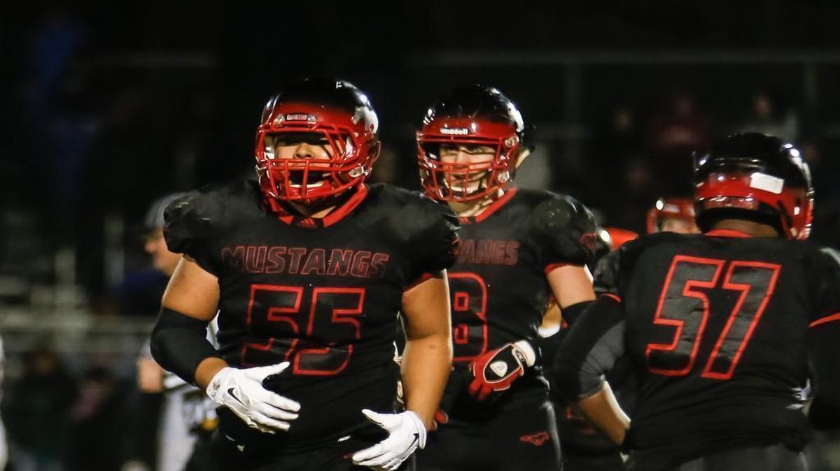 Middle Creek's Josh Drake (55) looks to the sidelines during Garner's third-round playoff game at Middle Creek on Friday, December 2, 2016. Middle Creek won the game 49-30.