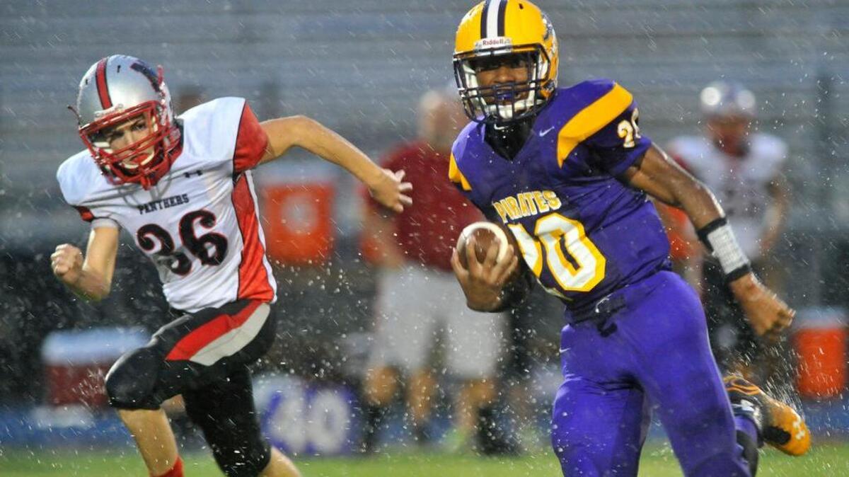 
Corinth Holders’ Howard Watson (20) leaves the backfield as North Johnson's Matthew Griswold (36) gives chase during a 44-14 win against the Panthers on September 5, 2014.
