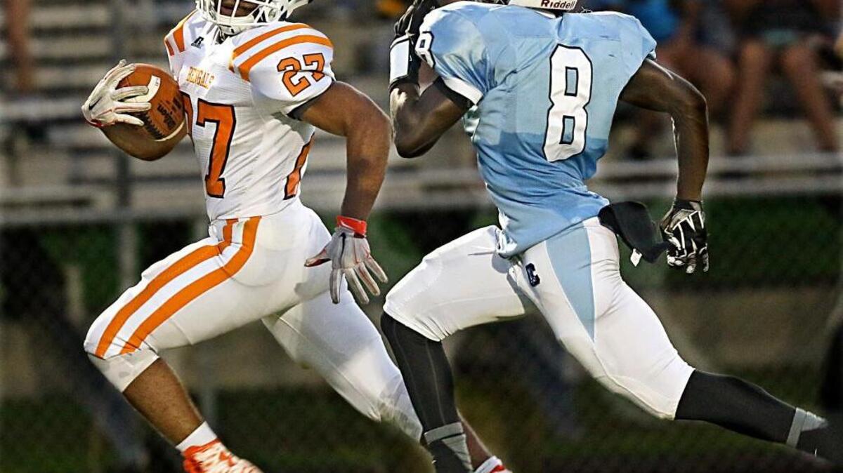 
Fuquay-Varina's Josh Arrington (27) eyes Cleveland's Josh Richardson (8) as he picks up a big gain that set up the first Fuquay touchdown. Fuquay leads at the half 28-22.
