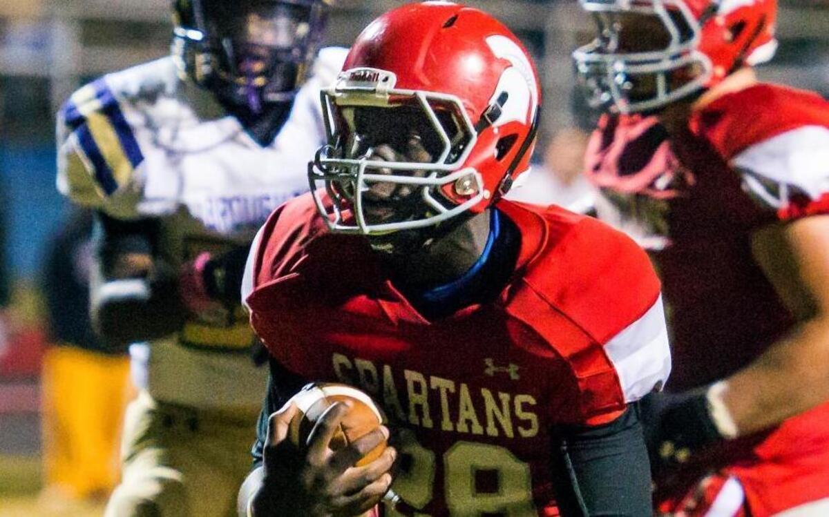 
Sanderson's Sam Vines (28) scores a toucdown during a football game against Broughton in Raleigh, N.C. on Friday, October 16, 2015. Sanderson Spartans won 28-19.
