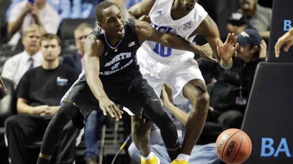 North Carolina’s Theo Pinson, left, and UCLA’s Isaac Hamilton fight for the ball during UNC’s 89-76 win over the Bruins on Dec. 19. Pinson, a 6-foot-5 sophomore, played power forward during the game when the Tar Heels went small.