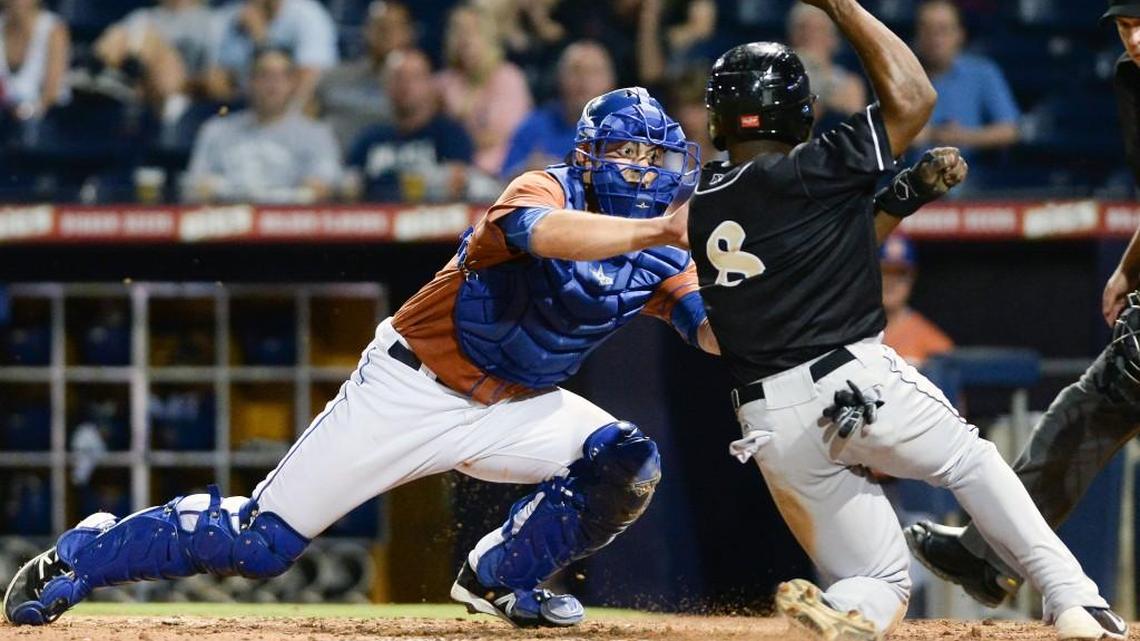 Durham Bulls' catcher Luke Maile, left, tags out Jason Bourgeois (8) of Charlotte Knights at home plate during the 8th inning. The Durham Bulls played the Charlotte Knights in a baseball game that took place at the Durham Bulls Athletic Park in Durham, N.C. on Tuesday, June 21, 2016. Durham Bulls won 3-1.